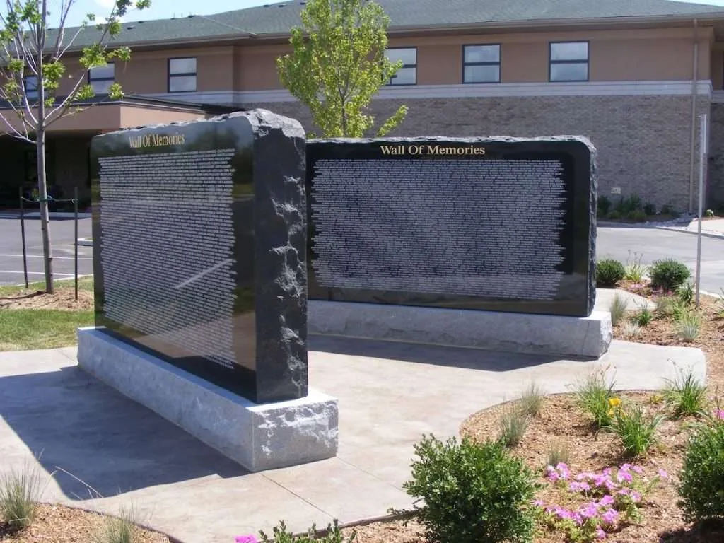 A large stone sculpture of two sides in front of a building.