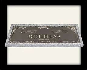 A sign that says douglas in front of a white wall.