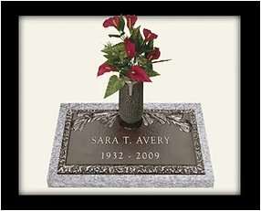 A vase with flowers in it on the ground.