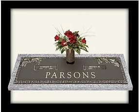 A vase of flowers on top of a plaque.